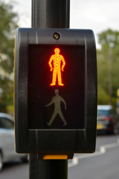 istock Corby, U.K., june 20, 2019 - push button wait for signal traffic light control with bright stop man illuminated at pedestrian crossing 1158278017