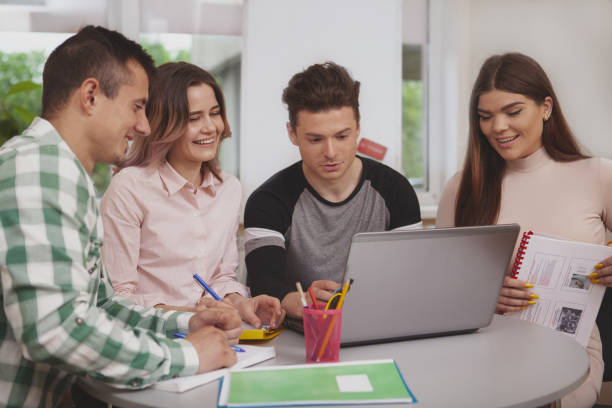 istock Group of young college students studying together at classroom 1158278088
