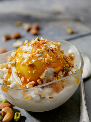 Vegan, Coconut Milk Vanilla Ice Cream Sundae with Caramel Sauce and Chopped Nuts