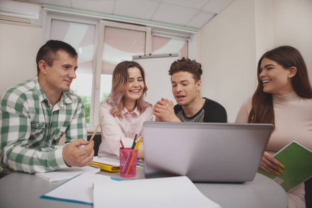istock Group of young college students studying together at classroom 1158278256