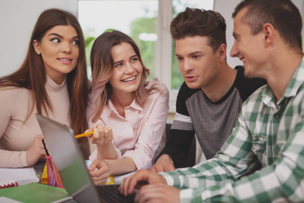 istock Group of young college students studying together at classroom 1158278314