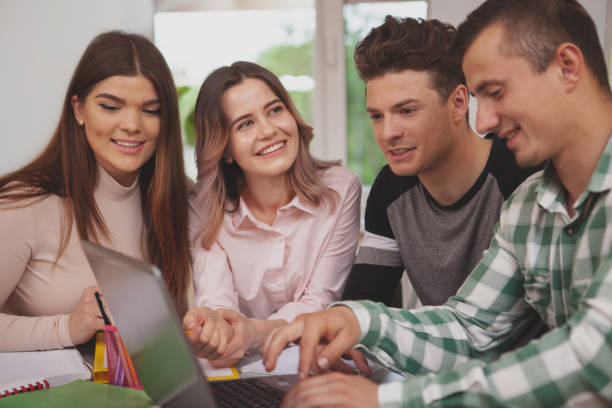 istock Group of young college students studying together at classroom 1158278334