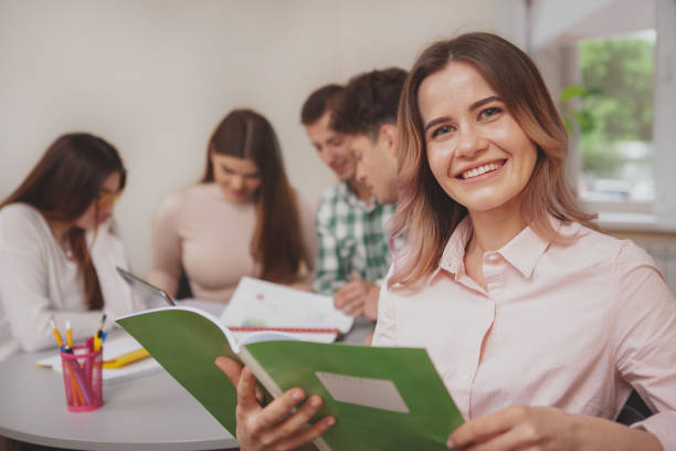 istock Group of young college students studying together at classroom 1158278347