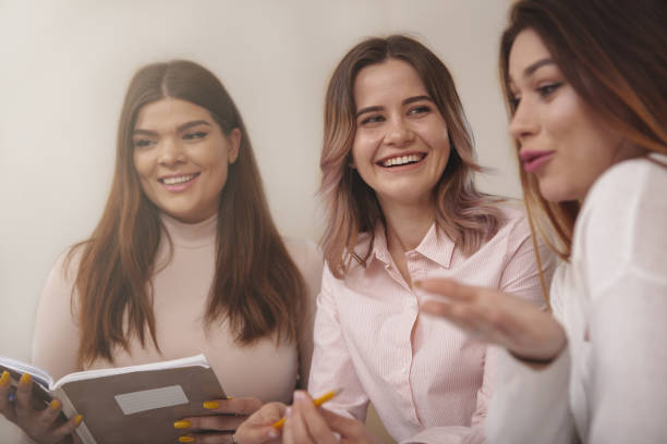istock Group of young college students studying together at classroom 1158278453