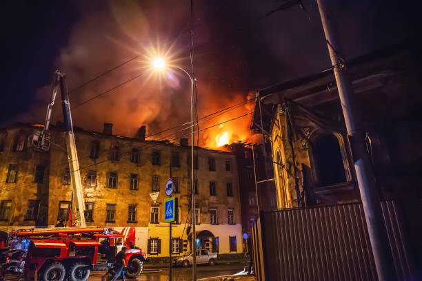 istock Night fire in apartment building, firefighters struggle with flame. Fire disaster and accident tragedy concept 1158287391
