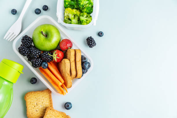 Healthy lunch to go packed in lunch box Healthy lunch to go. Fruits and vegetables packed in lunch box. Healthy eating concept. View from above with copy space. packed lunch photos stock pictures, royalty-free photos & images