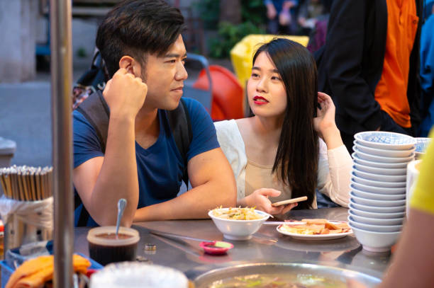 istock Asian couple enjoying a night market 1158288968