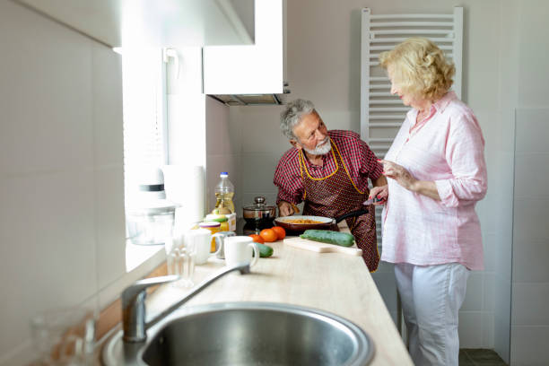 istock Senior couple preparing lunch 1158289644