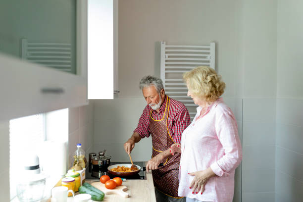 istock Senior couple preparing lunch 1158289661
