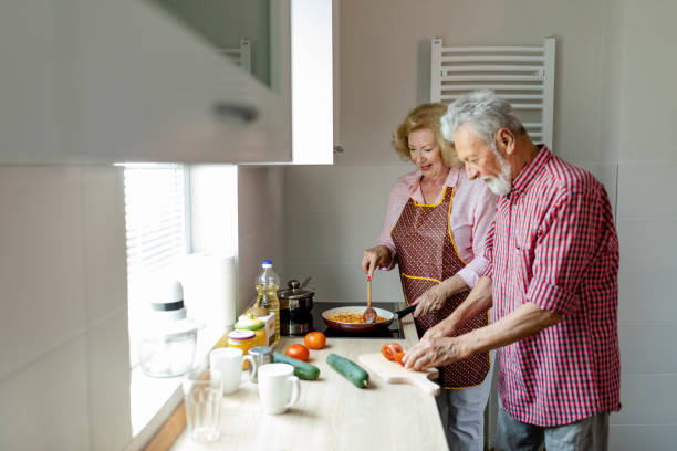 istock Senior couple preparing lunch 1158289662