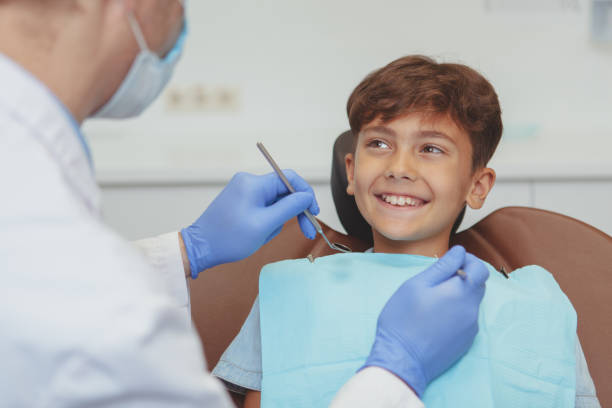 istock Little boy visiting dentist for medical checkup 1158290081
