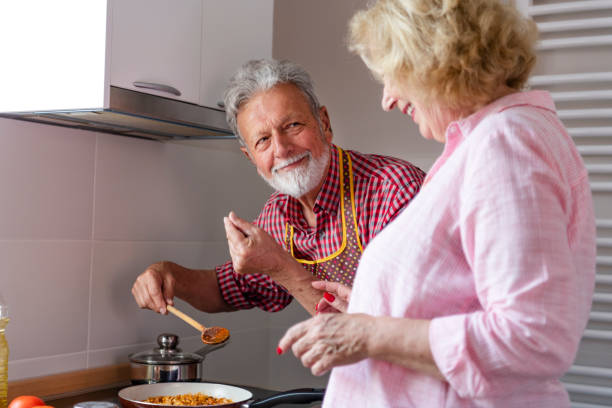 istock Senior couple preparing lunch 1158290222