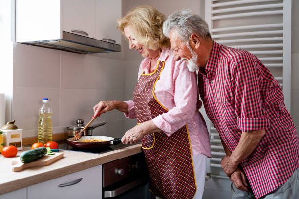 istock Senior couple preparing lunch 1158290785