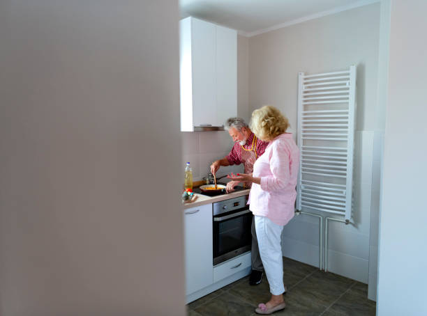 istock Senior couple preparing lunch 1158290808