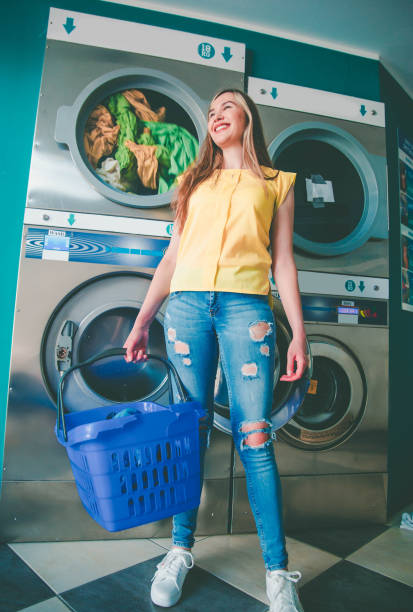 istock Smiling woman in laundry room 1158290819