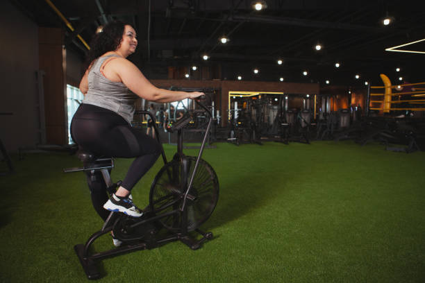 istock Lovely plus size woman exercising at the gym 1158294041