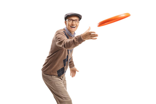 istock Cheerful elderly man playing with a frisbee 1158297266