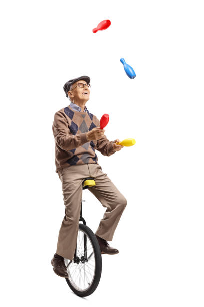 istock Elderly man juggling on a unicycle 1158298406