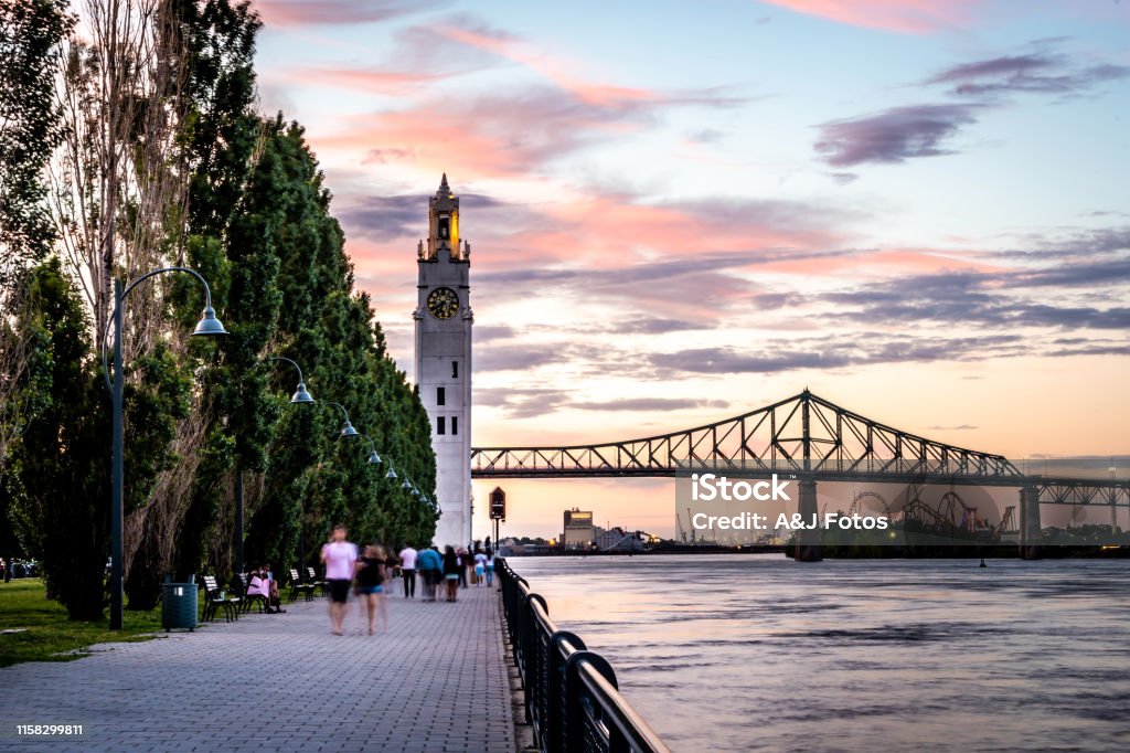 Montreal city at sunset. Montreal's old port at sunset with the clock tower and Jacques Cartier bridge in background. Montréal Stock Photo