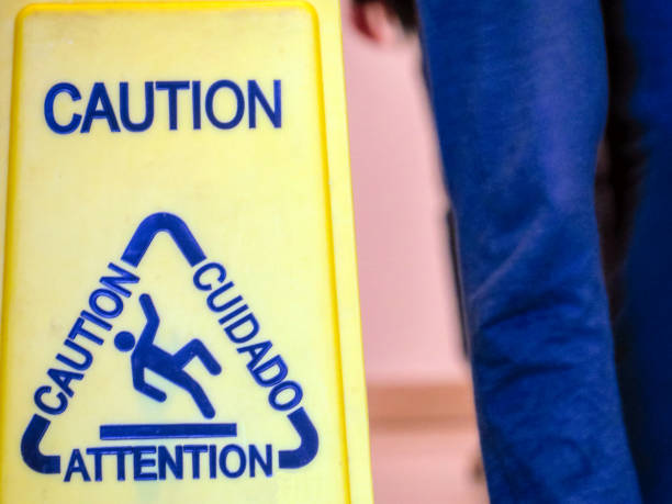 istock Caution sign and legs in hall 1158303340