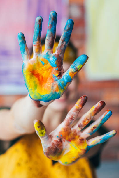 istock fun leisure artist hands blue yellow paint 1158304959