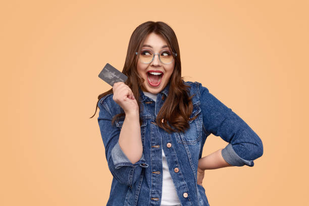 Excited curvy lady with credit card