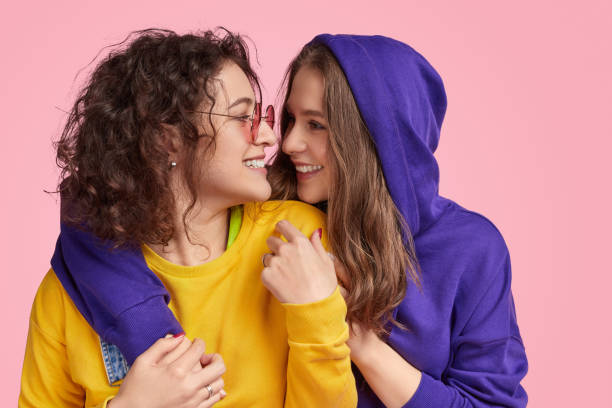istock Young women smiling and embracing each other 1158305299