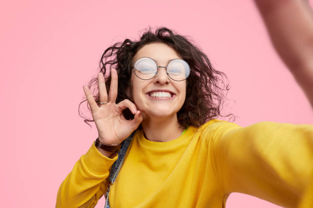 Hipster showing approving gesture and taking selfie