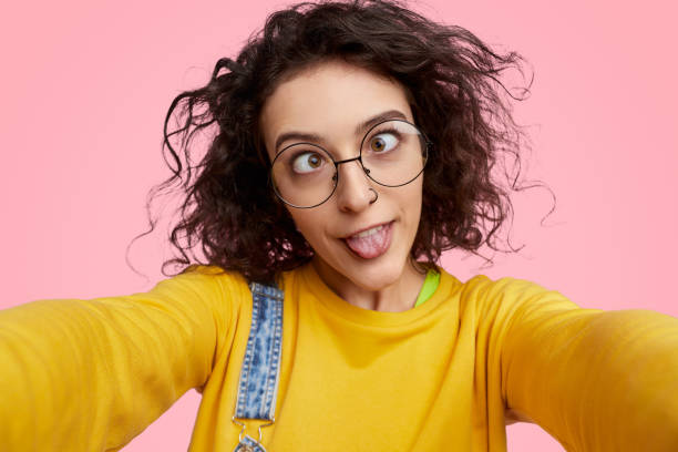 istock Silly young woman taking selfie 1158305326