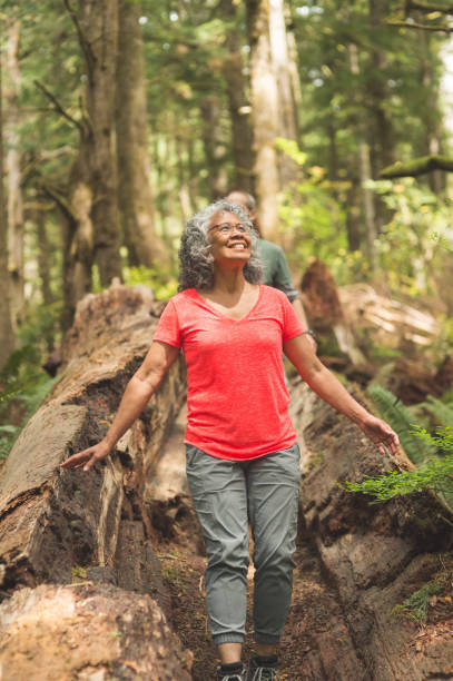 senior couple hiking in an oregon forest - old dirt road imagens e fotografias de stock