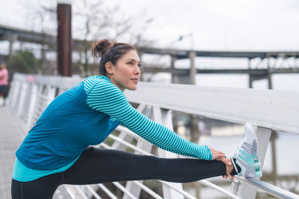 istock An woman stretches before going for a run in the city 1158307956