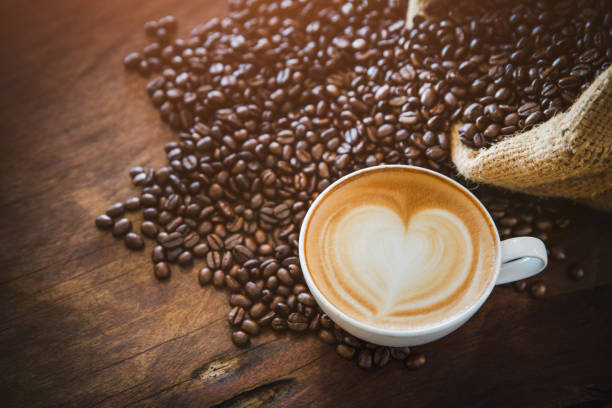 istock coffee latte with coffee beans  on dark background, top view 1158309699