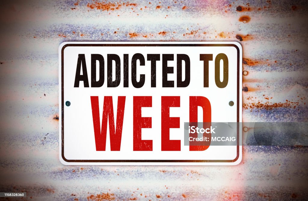 Addicted to Weed rustic sign that says "Addicted to Weed." Rebellion Stock Photo