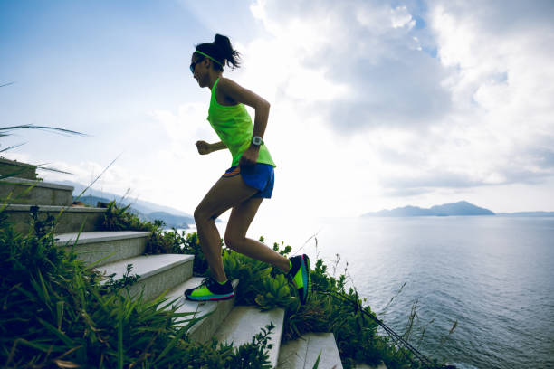 istock Determined woman running up on seaside mountain stairs 1158328465