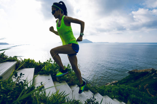istock Determined woman running up on seaside mountain stairs 1158328506
