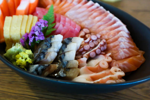 raw salmon, sashimi or sliced salmon and seafood raw salmon, sashimi or sliced salmon and sliced seafood frigate mackerel stock pictures, royalty-free photos & images