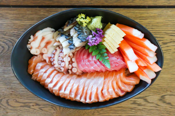 raw salmon, sashimi or sliced salmon and seafood raw salmon, sashimi or sliced salmon and sliced seafood frigate mackerel stock pictures, royalty-free photos & images
