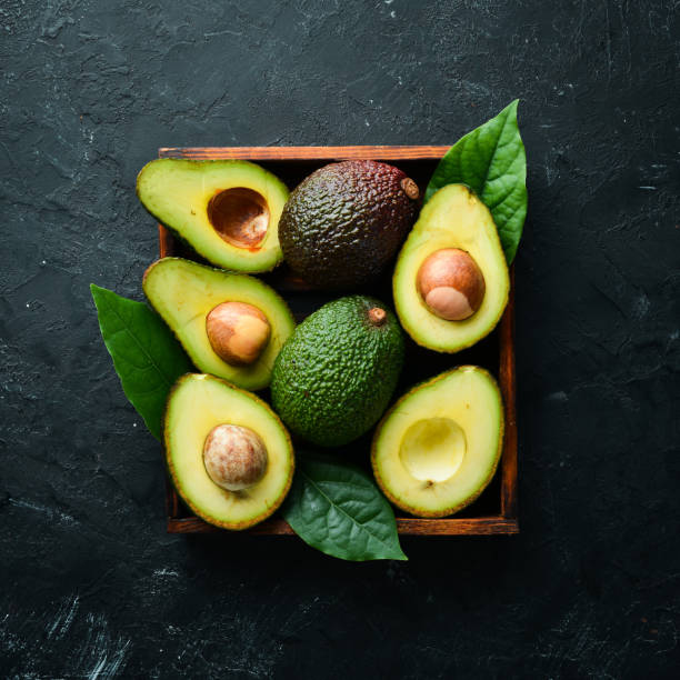 istock Avocado with leaves in the box. Rustic style. Top view. Free space for your text. 1158329746