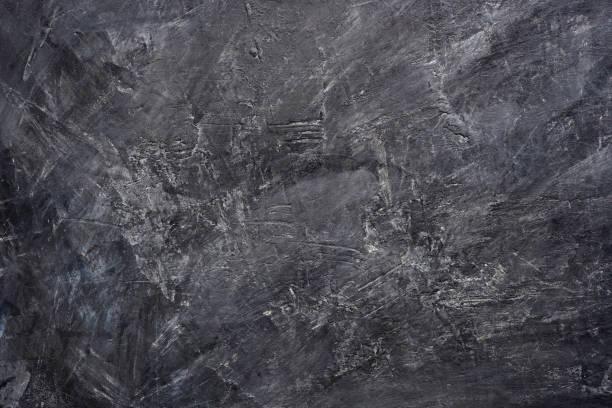 istock Texture of black color painting on cement wall. 1158330573