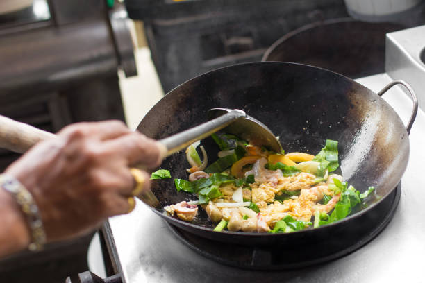istock Man hand is cooking Asian style in a pan 1158332803