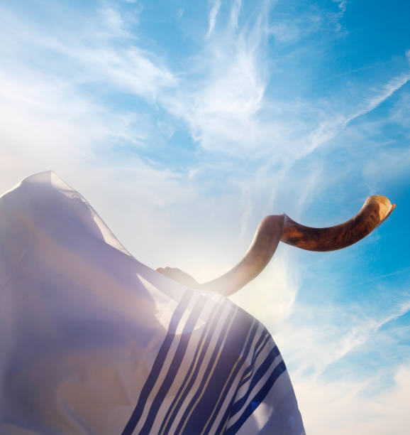 Close up on man Man with Shofar against blue sky