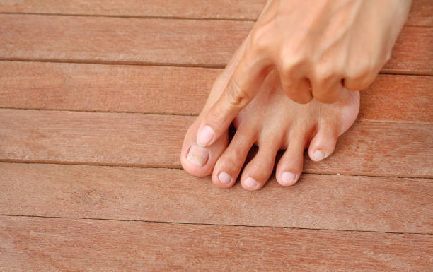 istock Point to Damaged toenail, broken nail 1158333964