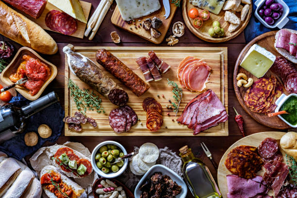 istock Tapas of cured ham and cheese delicious appetizer on rustic wood table with copy space 1158339476
