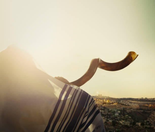 Jewish man blowing the Shofar in Jerusalem Close up on man Man with shofar looking at view of Jerusalem and the old city, Israel jewish prayer shawl stock pictures, royalty-free photos & images