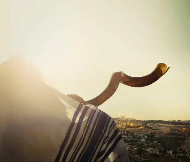 Close up on man Man with  shofar looking at view of Jerusalem and the old city, Israel