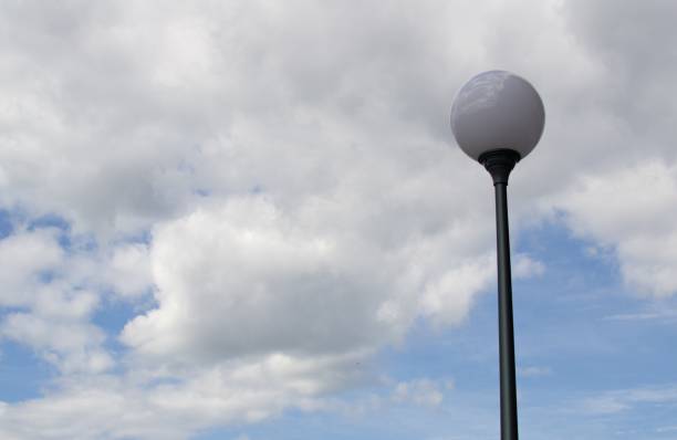 istock Round street lamp against a cloudy sky 1158341444