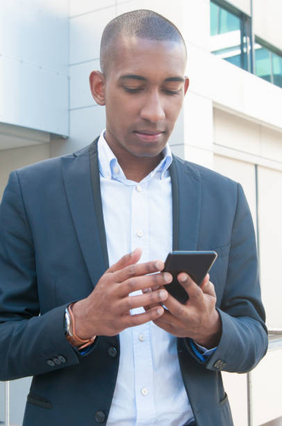 istock Serious pensive business leader texting message 1158342512
