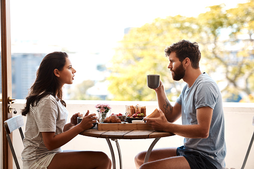 Shot of a young couple having an argument while eating breakfast at home