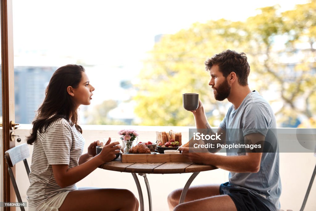 Bit of tension at the breakfast table Shot of a young couple having an argument while eating breakfast at home Couple - Relationship Stock Photo