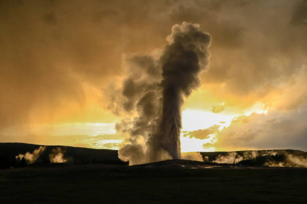 istock Old Faithful Stormy Sunset Eruption 1158343484